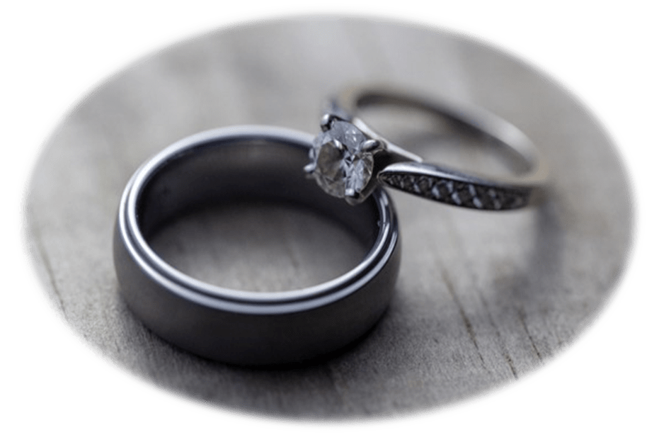 Two wedding rings on top of a wooden table