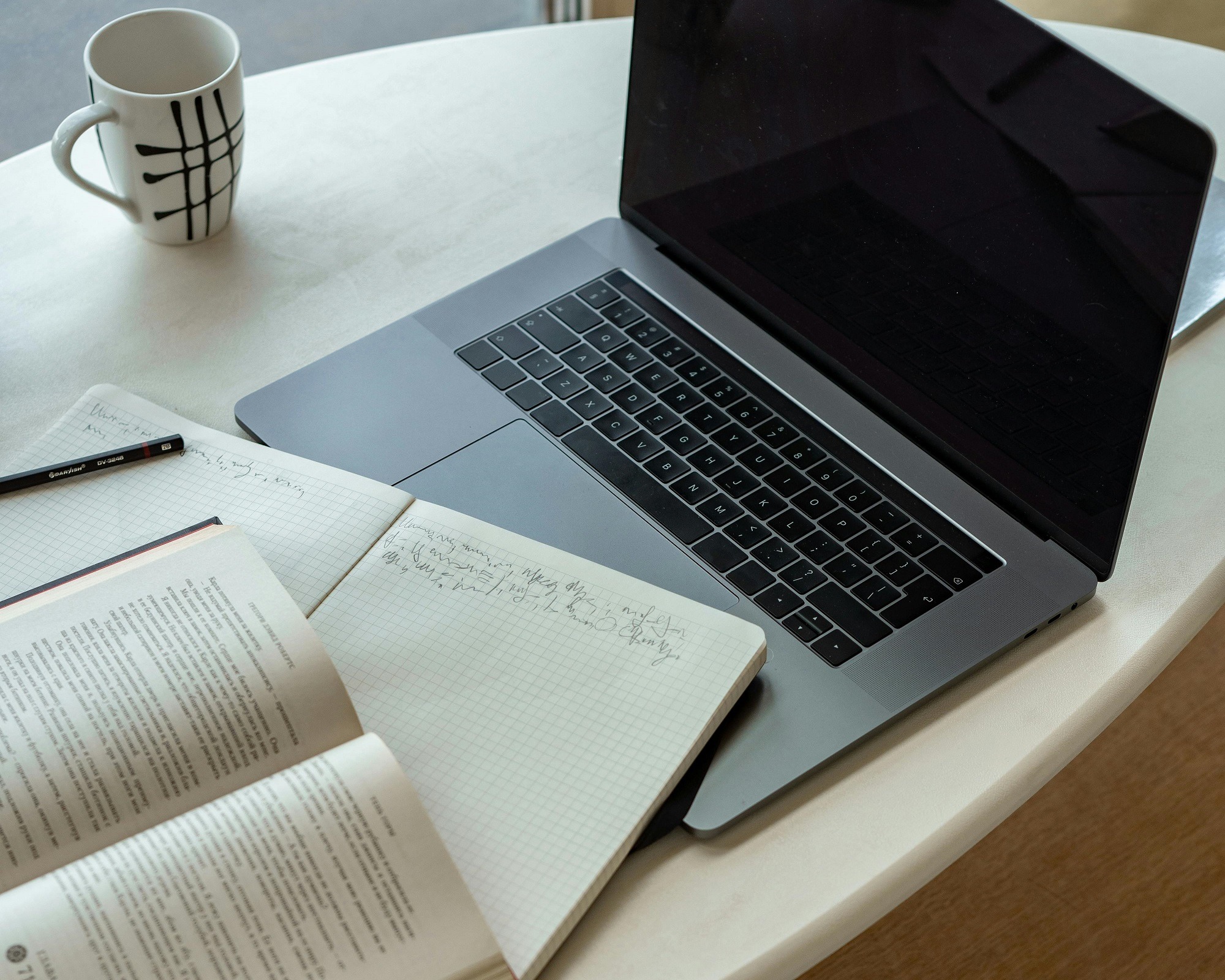 Laptop with coffee cup and paper document